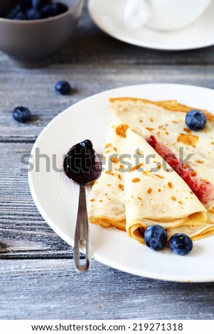 pancakes with jam and berries, side view
