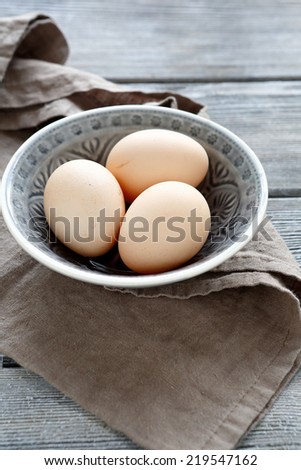 Bio eggs in a bowl on napkin, top view