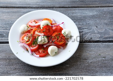 Vegetable salad with slices of cheese, top view