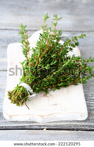 Fragrant thyme on a white chopping board, healthy herb