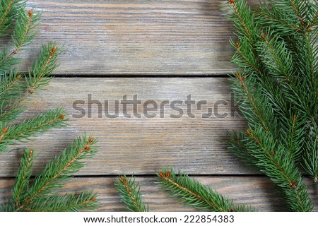 Frame with christmas pine branch on boards, xmas