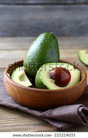 avocado in a wooden bowl, food close up on a napkin