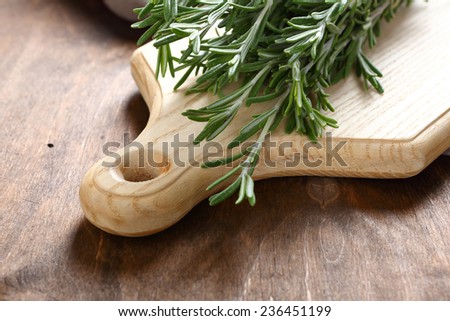 Fragrant rosemary on a cutting board, aroma herb