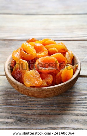Dried apricots in a bowl on the boards, sweet food