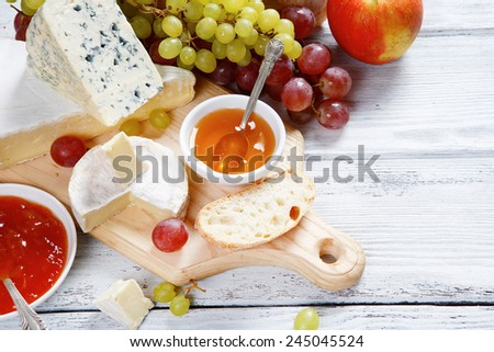 cheeses and fruits on boards, food