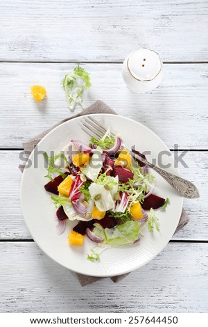 Light salad with oranges on a plate, food