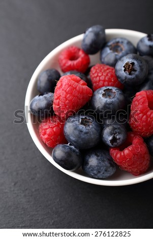 Fresh forest berries in a plate, food
