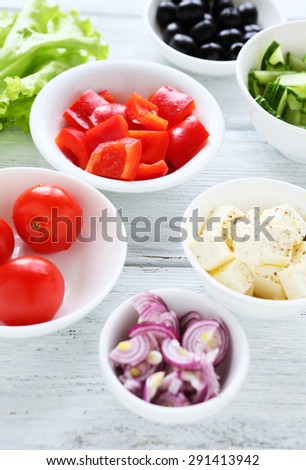 fresh greek salad ingredients on white table