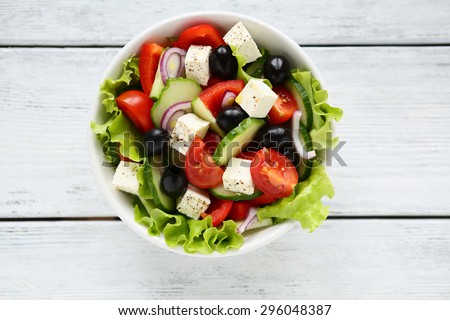 Fresh Greek salad in a bowl, top view