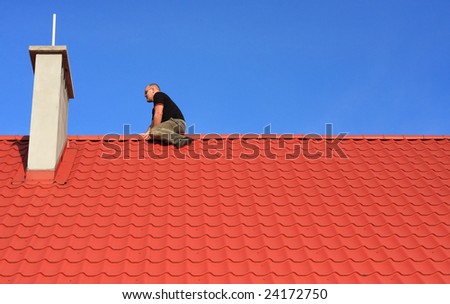 Young man sitting on a roof