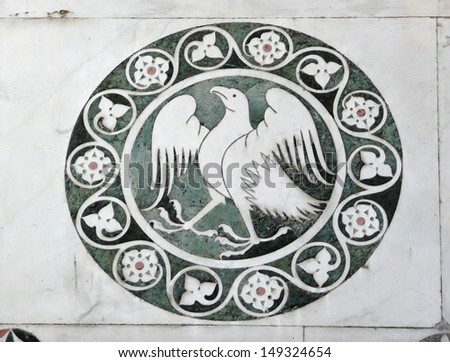 Marble ornament from wall of Cathedral of St Martin in Lucca in Italy
