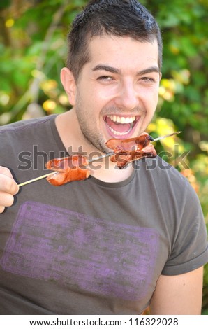 hungry man eating sausages
