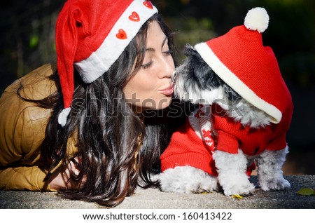 Beautiful Woman Hugging Her Dog With Red Christmas Hat