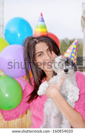 happy woman celebrating her birthday with her dog