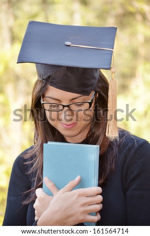 graduation woman portrait with book in the hands