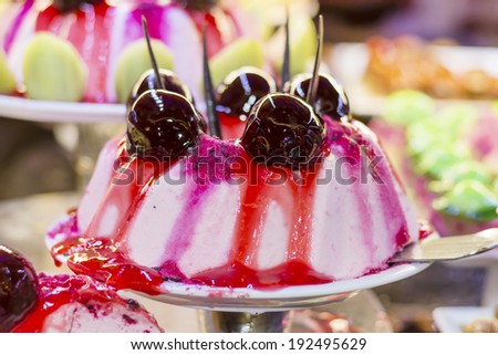 vanilla cream cake with cherry and strawberry glaze