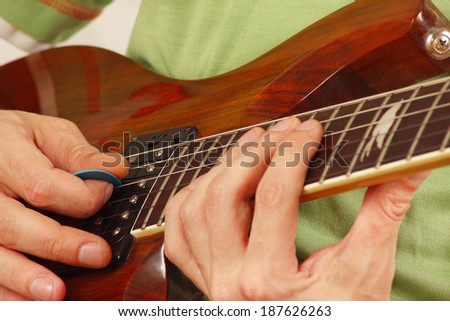 Posing hands of the guitarist playing the electric guitar