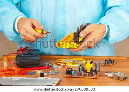 Hands service engineer of electronic equipment in the service workshop