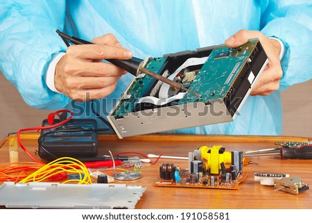Repair electronic board with a soldering iron in the service workshop