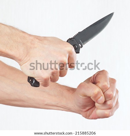 Hand position to attack with a army knife on a white background