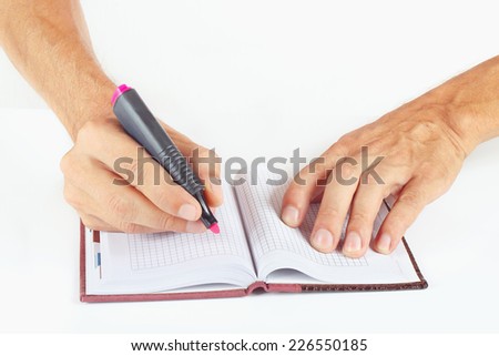 Hand written notes in red marker a notebook on a white background