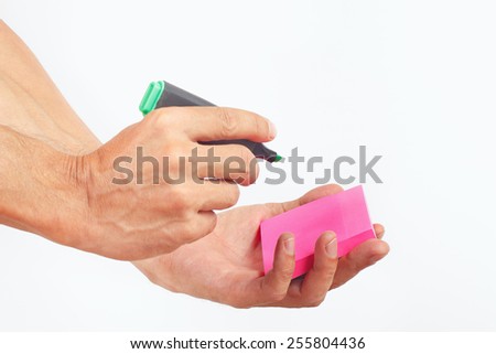 Hand written notes in green marker on a red sticker on a white background