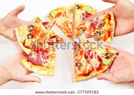 Child and adult hands with pieces of a pizza
