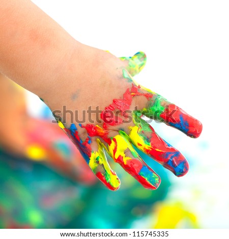 Close up of kids hand messed with colorful paint. Isolated on white.
