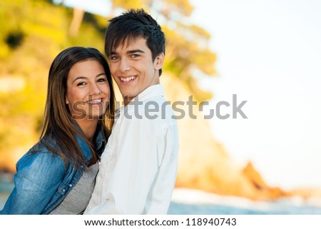 Close up portrait of happy young couple at seaside.