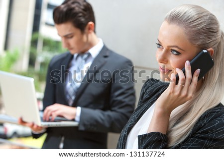 Close up portrait of elegant businesswoman talking on smart phone at outdoor meeting.