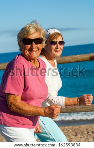 Portrait of friendly senior ladies in casual sportswear outdoors.