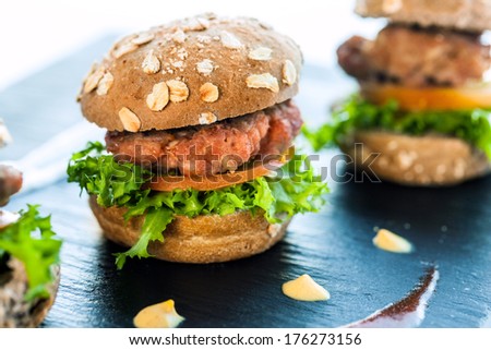 Macro close up of mini organic hamburger in catering buffet.
