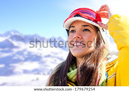 Young attractive girl wearing goggles and anorak ready for winter sport.