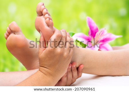 Close up of female therapist hands doing foot massage.