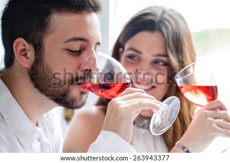 Close up portrait of Couple enjoying and drinking wine at tasting.