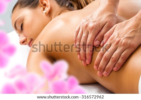 Close up of Hands doing Relaxing back massage on woman in spa.