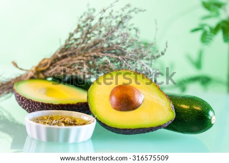 Macro close up Avocado with essential oil and aromatic dried rosemary.