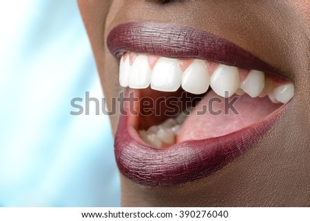 Macro close up of african female mouth.Open mouth showing perfect white teeth.