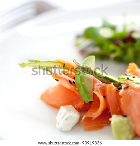 Close up of smoked salmon salad with green asparagus and avocado