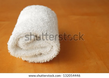 white towel roll on wooden panel with copy space