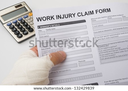 hurted hand holding a work injury claim form, medical and insurance concept