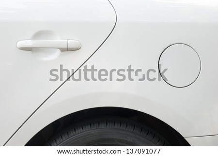 door and tyre and petrol cap cover of a white car