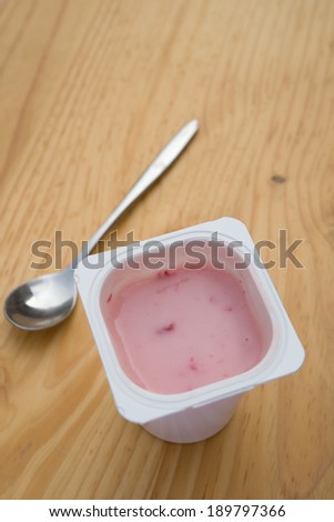 strawberry flavor yogurt on wooden table