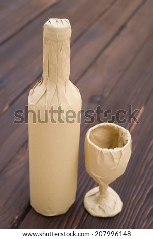 wine and cup wrapped up on wood background