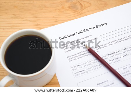 customer service satisfaction survey form and cup of coffee