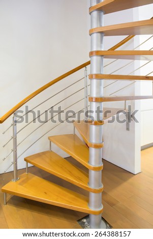 morden spiral stairs with wooden steps inside a house