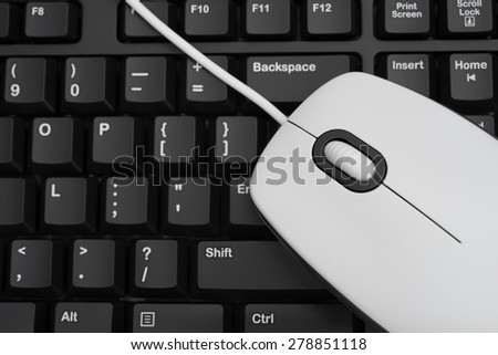 white mouse over black keyboard