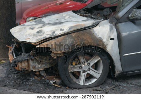 side of a burnt out car in an outdoor park