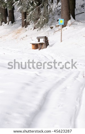 Bench on a lookout point in winter on the edge of a forest near the cross country track at Gutenbrunn in the region of the Waldviertel in Lower Austria