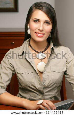 elegant young woman with jewelry works at office
